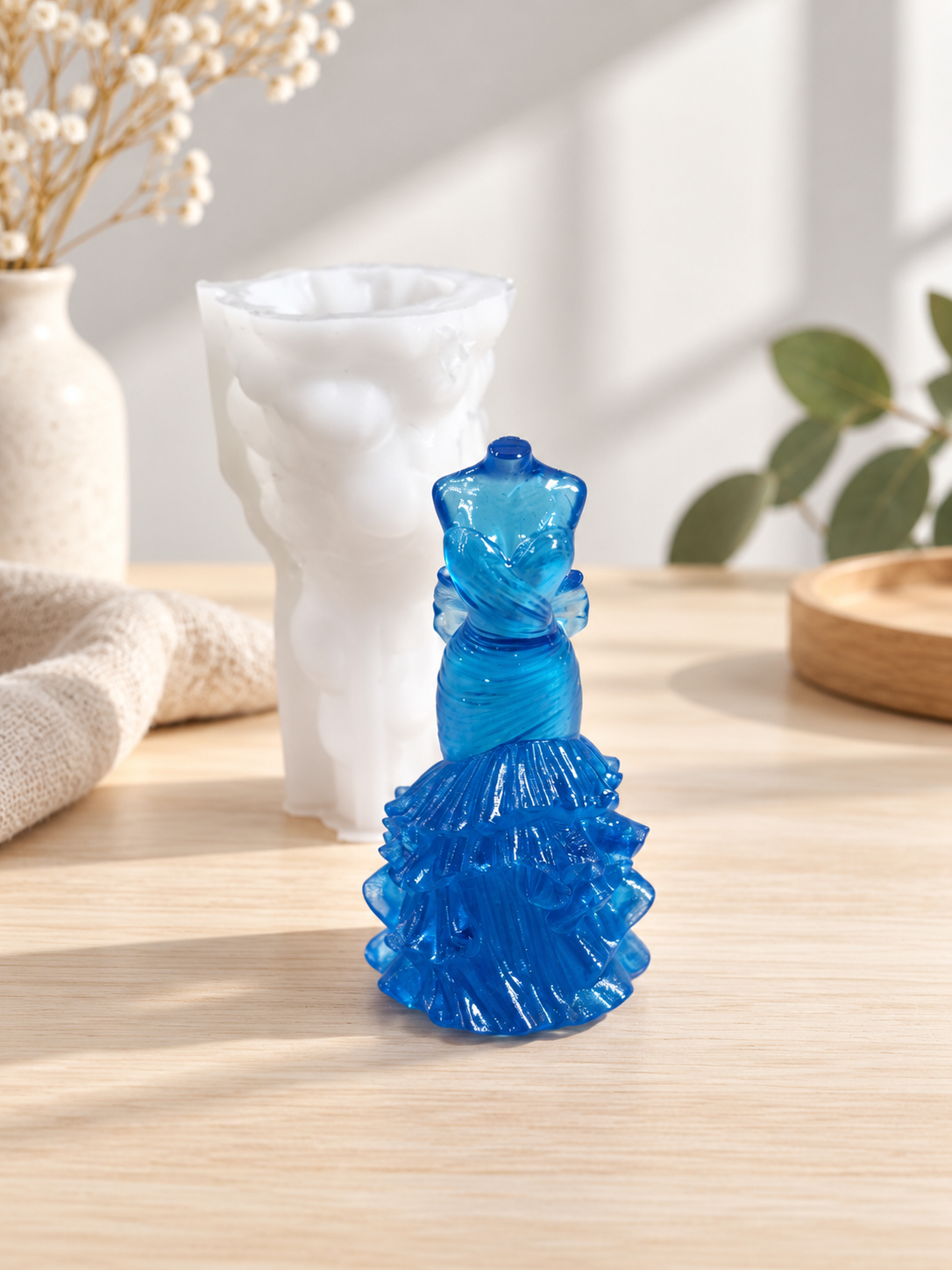 Elegant evening dress silicone mold with a finished blue resin dress casting